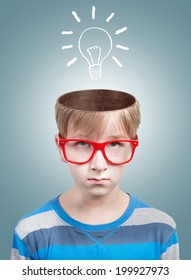 Funny boy looking at camera with a drawn electric bulb under his opened head. Concept - Shutterstock ID 199927973