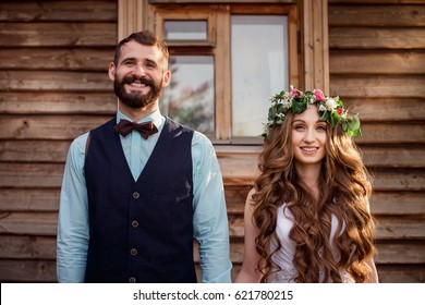 Funny Bride And Groom At The Wooden House. Newlyweds.