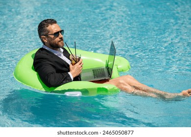 Funny business man relaxing in suit on swimming pool. Summer vacation, business on sea beach. Summer rest, business people concept. Wealthy business man relaxing in swimming pool. Remote on-line work. - Powered by Shutterstock