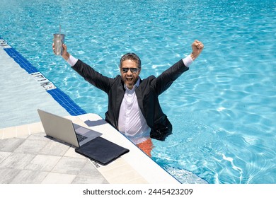 Funny businessman. Business success. Funny office worker online work, e-working. Fun business. Summer businessman in suit with laptop in sea pool water. Hot business funny summer. Fun business travel. - Powered by Shutterstock