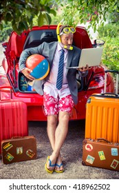 Funny Businessman Ready To Trip. Man Standing Near Red Car. Summer Vacations And Travel Concept