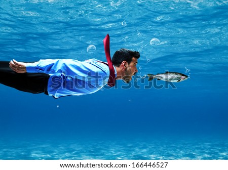 Funny businessman swimming underwater