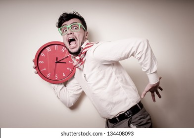 funny businessman with wall clock on gray background
