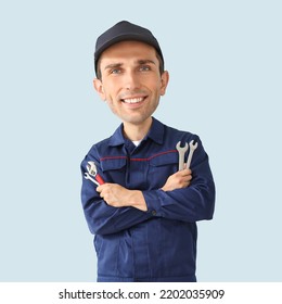 Funny Car Mechanic With Big Head On Light Background