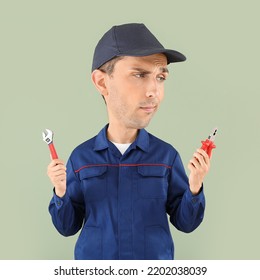 Funny Car Mechanic With Big Head And Different Tools On Color Background