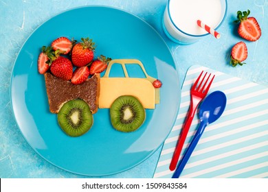 Funny Car Truck Sandwich With Chocolate Paste, Strawberries, Kiwi And Cheese. Kids Food Idea. Children's Breakfast With Sandwich, Berries And Milk. Top View
