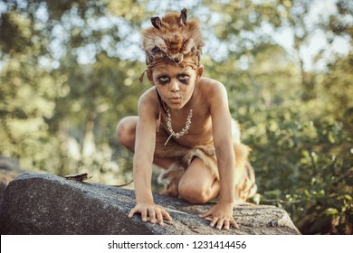 Funny Caveman, Manly Boy. Prehistoric Tribal Man Outdoors On Nature. Primitive Ice Age Man In Animal Skin. Reconstruction Of Neanderthal And Cro-magnon Life