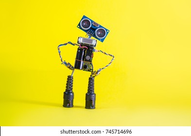 Funny Cheerful Cute Charming Robot On A Yellow Background