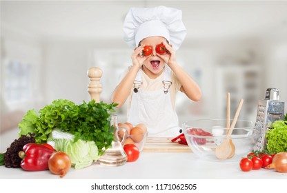 Funny chef girl cooking at kitchen