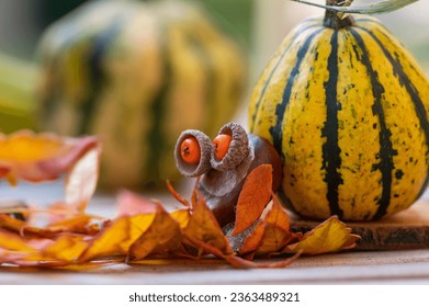 Funny chestnut owl bird animal with cute face berry eyes leaves wings on wooden bench, ripened pumpkins on background, traditional autumnal handcraft with children - Powered by Shutterstock