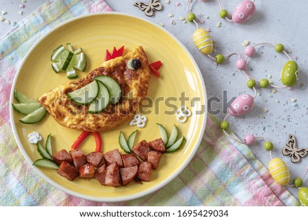 Funny chick egg omelette with ham vegetables for kids breakfast