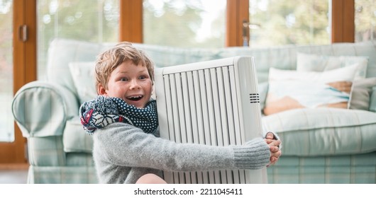 Funny child boy hugs radiator. Kid in warm clothes. Heating of housing during the energy crisis in the winter cold season. Restrictions and savings of gas and electricity. Heat. Comfort. - Shutterstock ID 2211045411