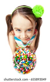 Funny Child With Candys Licking Her Lips, Isolated On A White Background. Happy Little Girl With Sweets. Facial Expression.