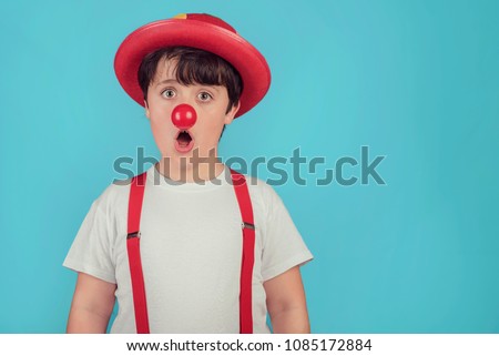 Similar – funny child with clown nose on blue background