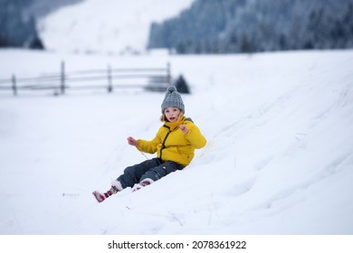 Funny Child, Cute Girl Playing In Winter Snowy Park. Christmas Holiday, Winter Weekend For Kids.