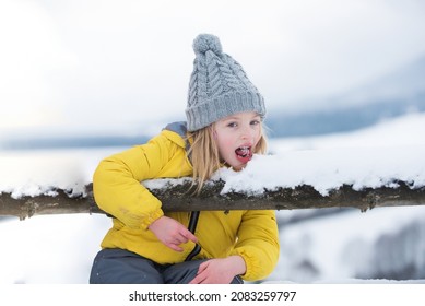 Funny Child, Cute Girl Playing In Winter Snowy Park. Christmas Holiday, Winter Weekend For Kids.