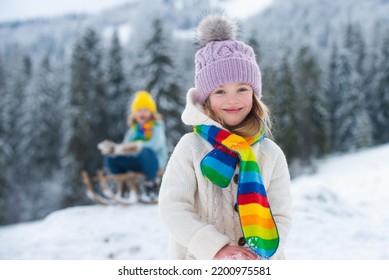 Funny Child, Cute Girl Playing In Winter Snowy Park. Christmas Holiday, Winter Weekend For Kids.