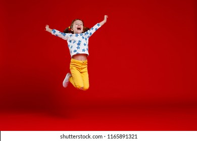 funny child girl jump wearing glasses on a colored background 
 - Powered by Shutterstock