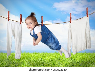 Funny Child Hanging On Line With Clothes, Laundry Creative Concept