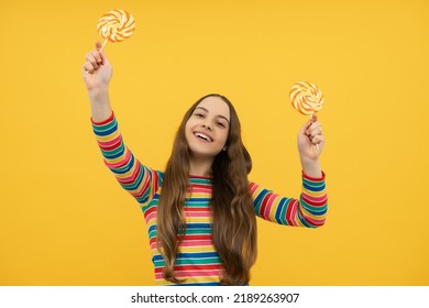 Funny Child With Lollipop Over Yellow Isolated Background. Sweet Childhood Life. Teen Girl With Yummy Caramel Lollipop, Candy Shop. Teenager With Sweet Sucker.