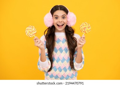 Funny Child With Lollipop Over Yellow Isolated Background. Sweet Childhood Life. Teen Girl With Yummy Caramel Lollipop, Candy Shop. Teenager With Sweet Sucker.