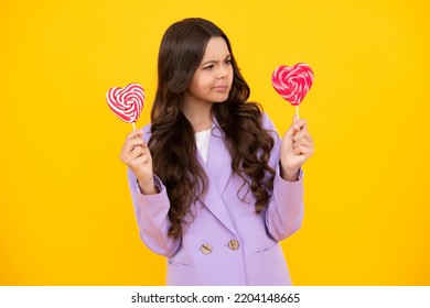 Funny Child With Lollipop Over Yellow Isolated Background. Sweet Childhood Life. Teen Girl With Yummy Caramel Lollipop, Candy Shop. Funny Face.