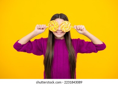 Funny child with lollipop over yellow isolated background. Sweet childhood life. Teen girl with yummy caramel lollipop, candy shop. Teenager with sweet sucker. - Powered by Shutterstock