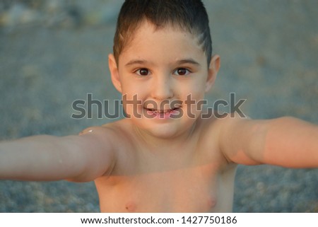 Similar – Cute little boy toaching the water with his feet.