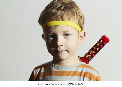 funny child play ninja.Little Boy with ninja sword.Masquerade.Unusual