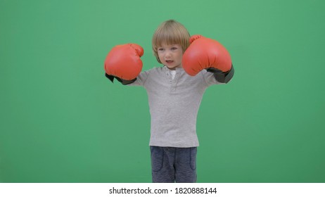 Funny child playing with red box gloves, threat with fight,  green screen - Powered by Shutterstock