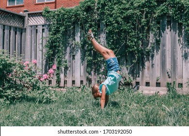 Funny child teenage girl doing cartwheel upside down stand. Excited joyful kid playing outdoor. Happy lifestyle childhood and freedom spirit. Seasonal summer sport activity for children.
