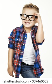Funny child.fashionable little boy in glasses, jeans, white t-shirt and plaid shirt.stylish kid  in shock and surprise. fashion children
