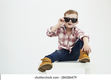 Funny child.fashionable little boy in sunglasses.stylish kid in yellow shoes. fashion children