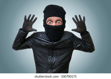 Funny childlike burglar or bandit puts hands up.