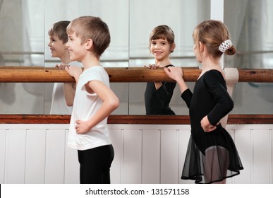 funny children standing at ballet barre
