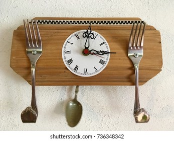 Funny Clock With Forks And Spoon Hanging On A Kitchen Wall/time For Eating, Creativity In Everyday Life /time Passing By