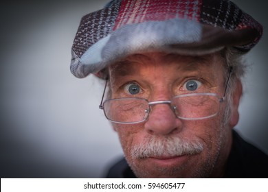 Funny Closeup Picture Of A Scruffy Older Man, Making A Goofy Face
