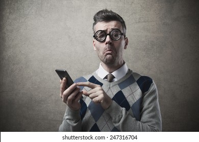 Funny clueless dumb guy having troubles with his smartphone