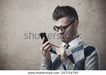 Funny clueless dumb guy having troubles with his smartphone