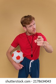 Funny Coach With Soccer Ball On A Beige Background