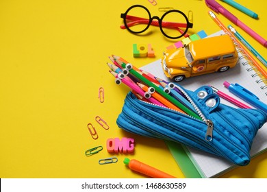 Funny colorful Back to School concept - office and student supplies on yellow background. Space for text.