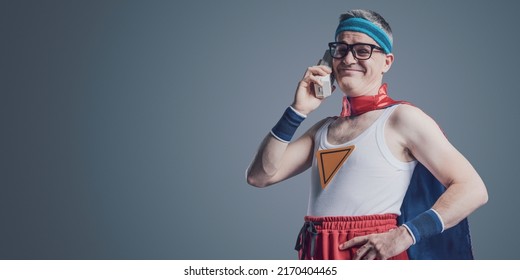 Funny Confident Superhero Making A Phone Call Using An Old Obsolete Cordless Telephone