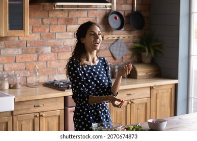 Funny Cooking. Joyful Millennial Latina Woman Prepare Food At Home Kitchen In Good Mood Juggle With Cherry Tomatoes Having Fun. Inspired Young Lady Relieve Stress When Cook Meal From Natural Products