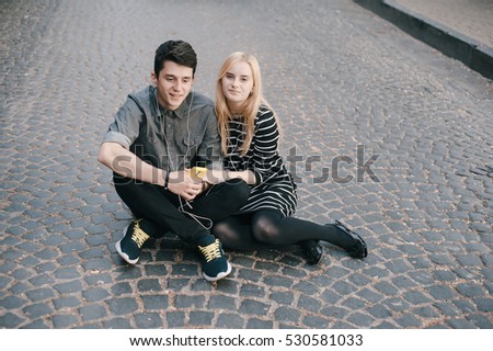 funny couple walking in the city and the park and eat ice cream