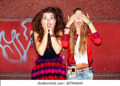 Funny crazy emotional pretty girls having fun and surprised ofter night party together on the street background in city 