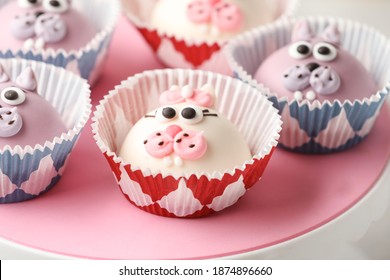 Funny Cupcakes Shaped Cat On Pink Cake Turntable. Close Up, Selective Focus.