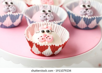 Funny Cupcakes Shaped Cat On Pink Cake Turntable. Close Up, Selective Focus.