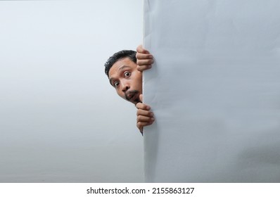 funny curious man peeking behind the wall - Shutterstock ID 2155863127
