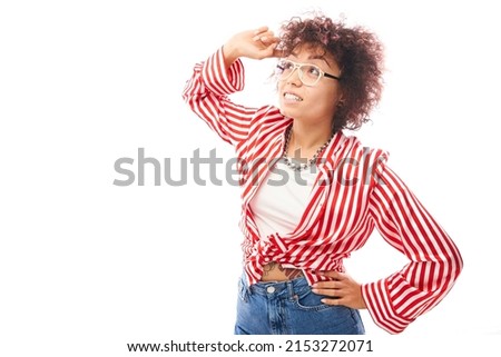 Funny curly girl touching her head thinks doubts, makes decision isolated on white studio background