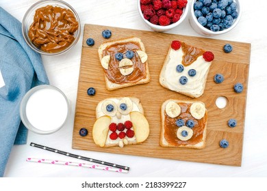 Funny Cute Bear,monkey,fox,owl Faces Sandwich Toast Bread With Peanut Butter,banana,blueberry,raspberry,milk. Kids Childrens Baby's Sweet Dessert Healthy Breakfast Lunch Food Art,close Up,top View.